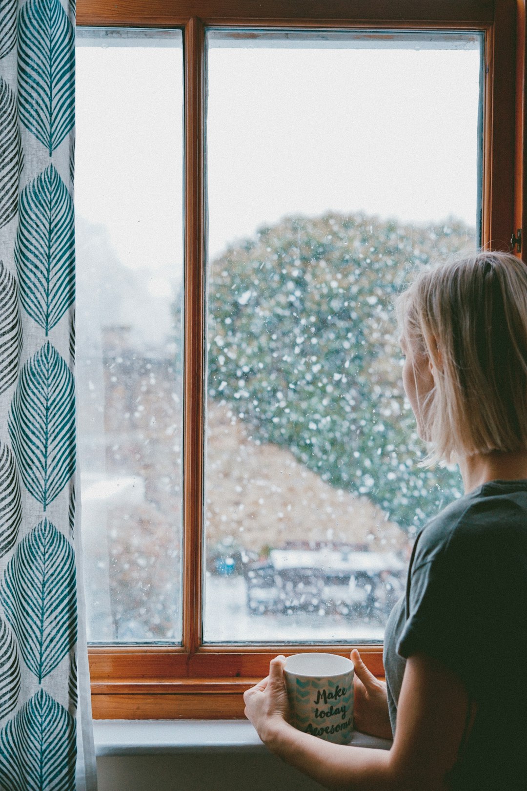 woman standing in front of clear glass window