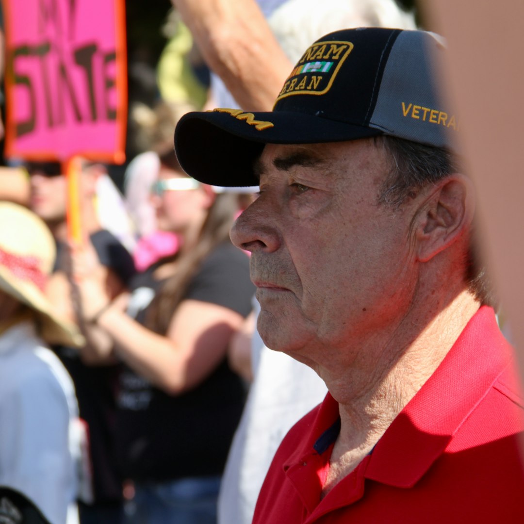 Photo by Manny Becerra man in red polo shirt wearing black cap