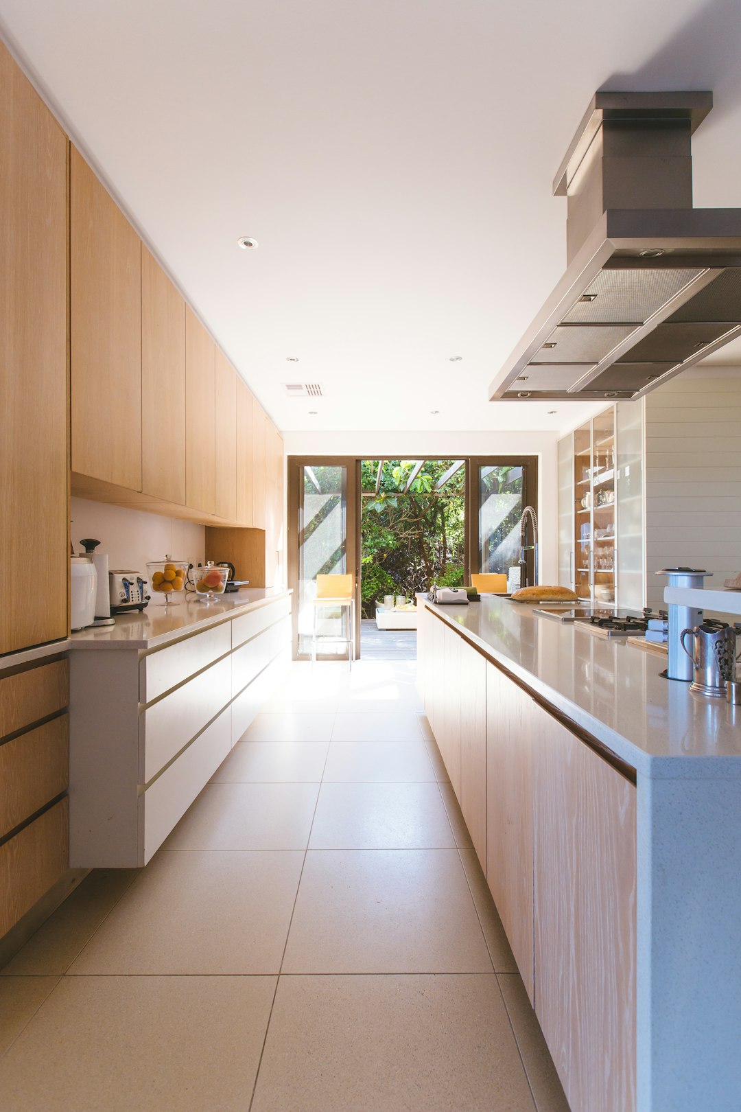 Photo by Jason Briscoe white wooden kitchen island and cupboard cabinets near glass panel door