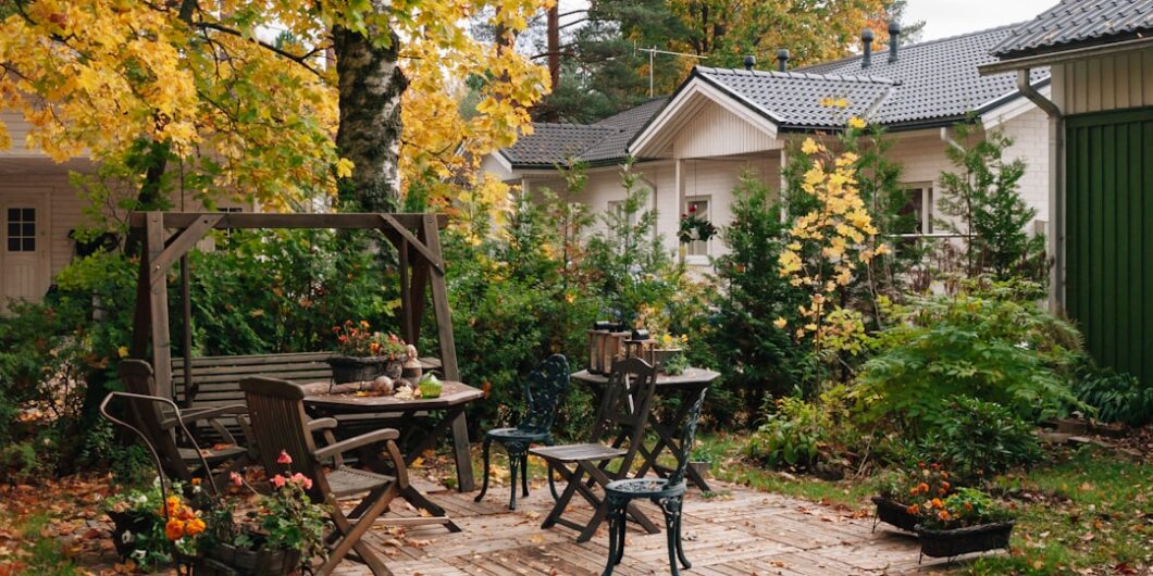 Photo by Nick Night a patio with a table, chairs and a bench