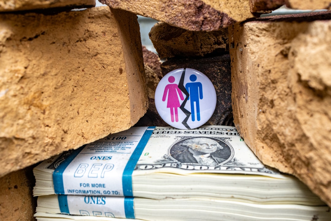 Photo by Marek Studzinski a pile of money with a button on top of it