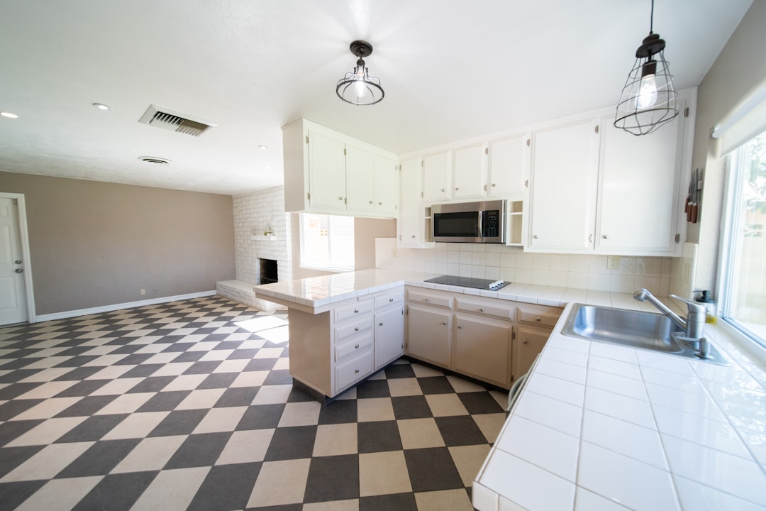 A kitchen with a checkered floor and a sink