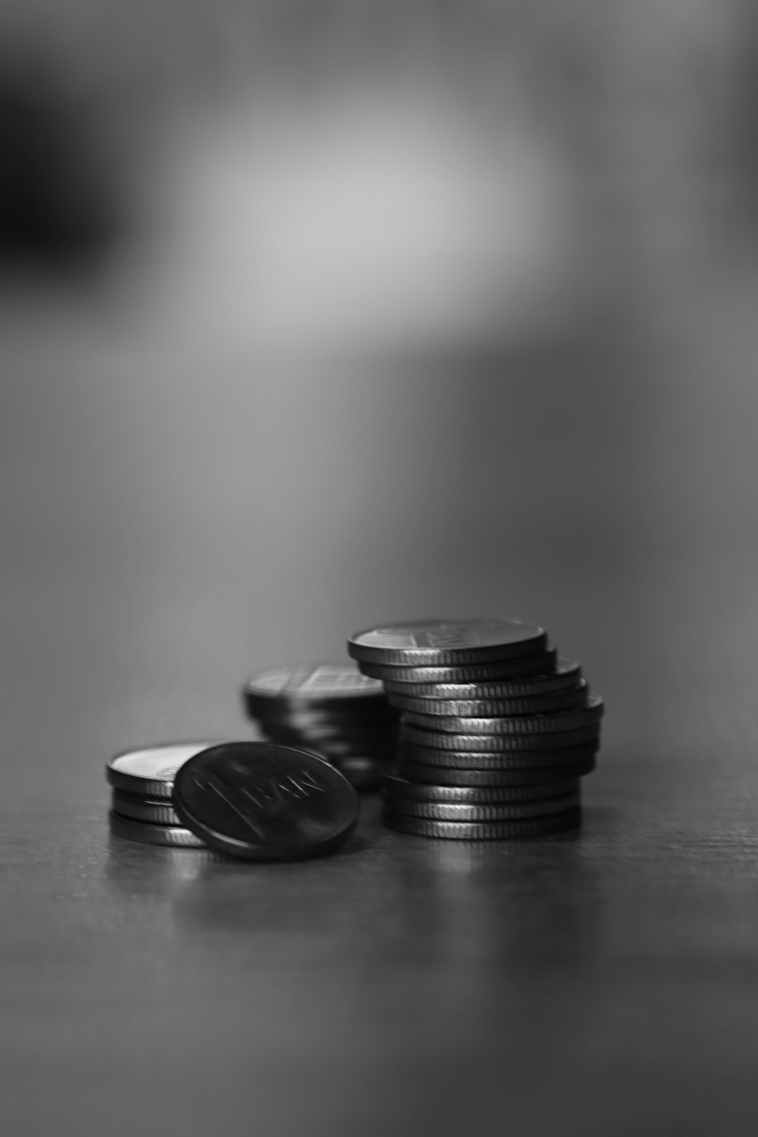 Photo by Alexandra Dobrin a stack of coins sitting on top of a table
