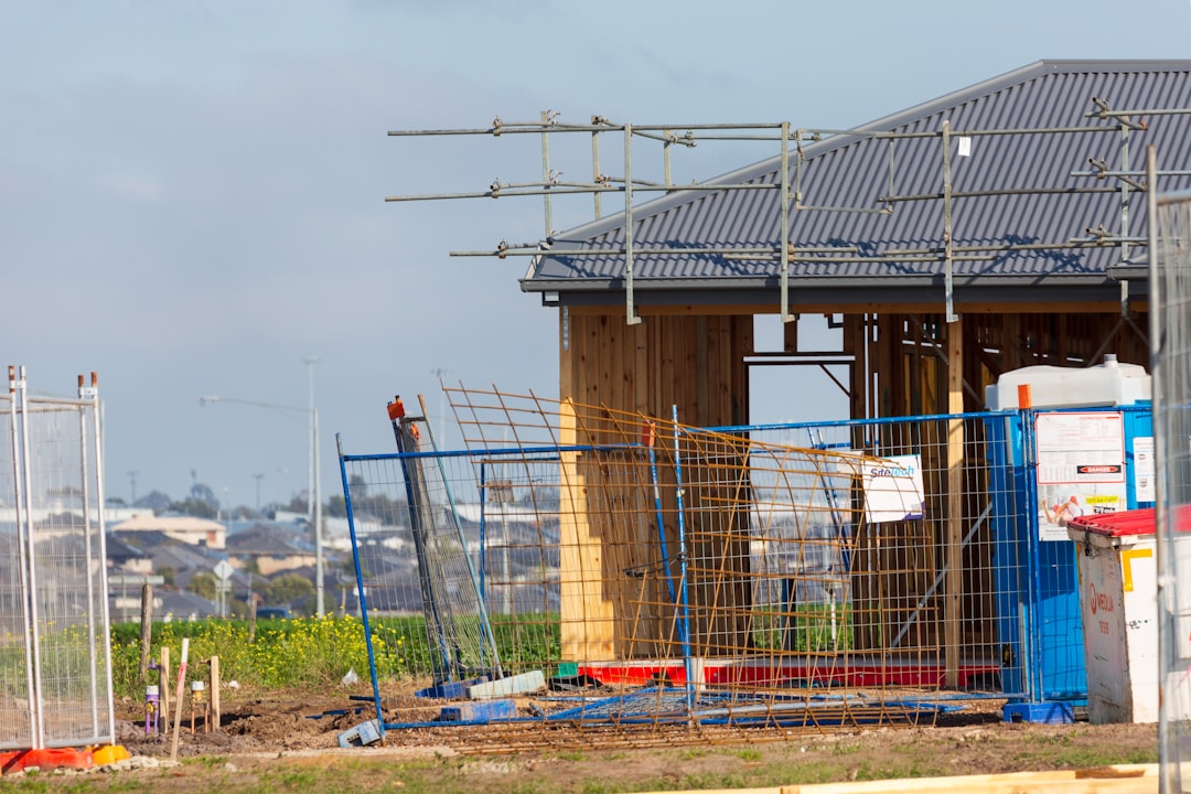 Photo by Troy Mortier a building under construction with lots of scaffolding