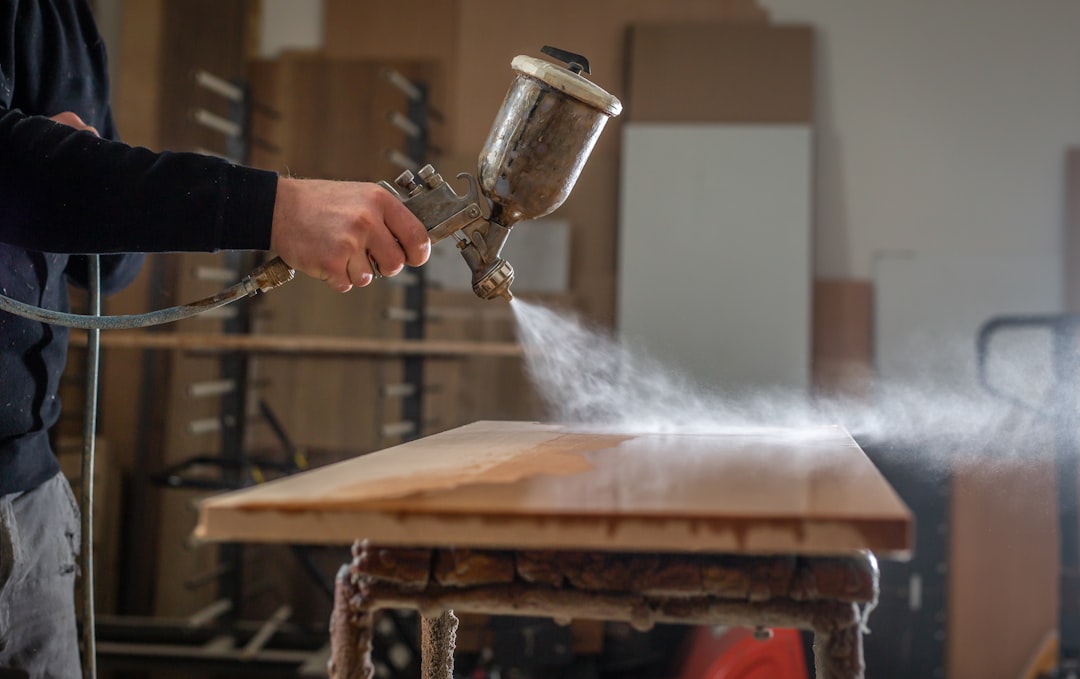 Photo by Simon Kadula a person using a grinder on a wooden table