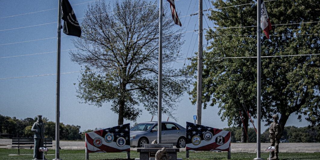a group of flags on poles
