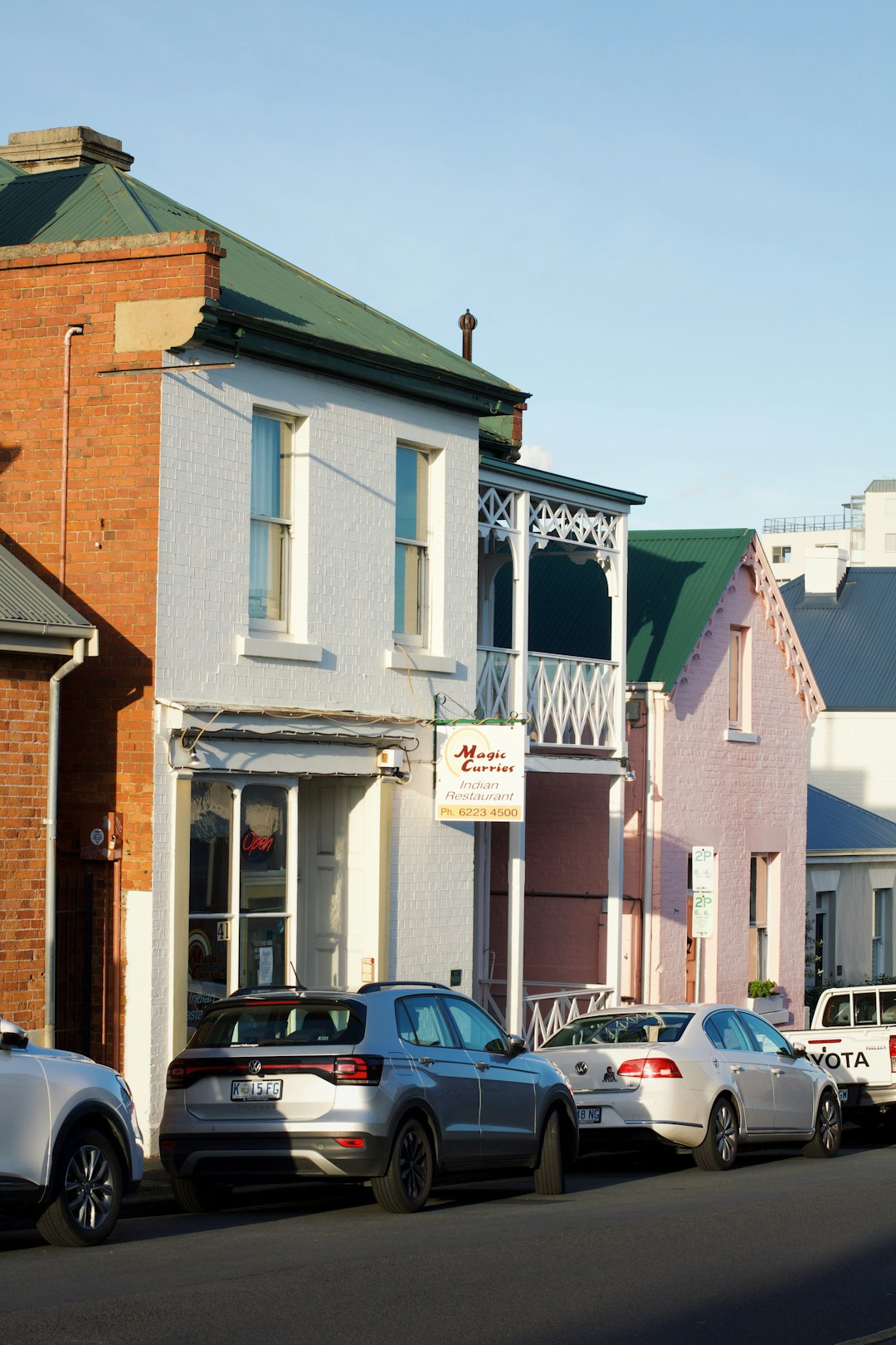 A row of parked cars on a city street