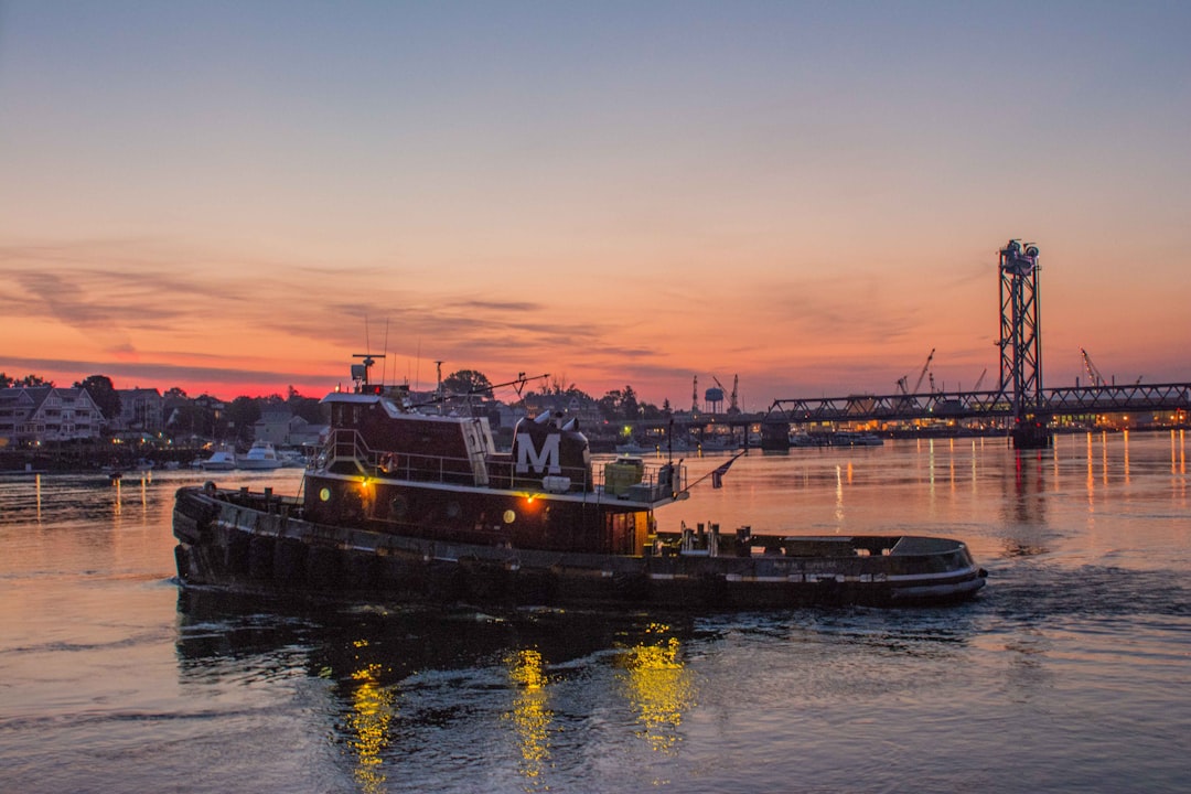 Photo by Billy Hayes pontoon boat with bridge as background photo