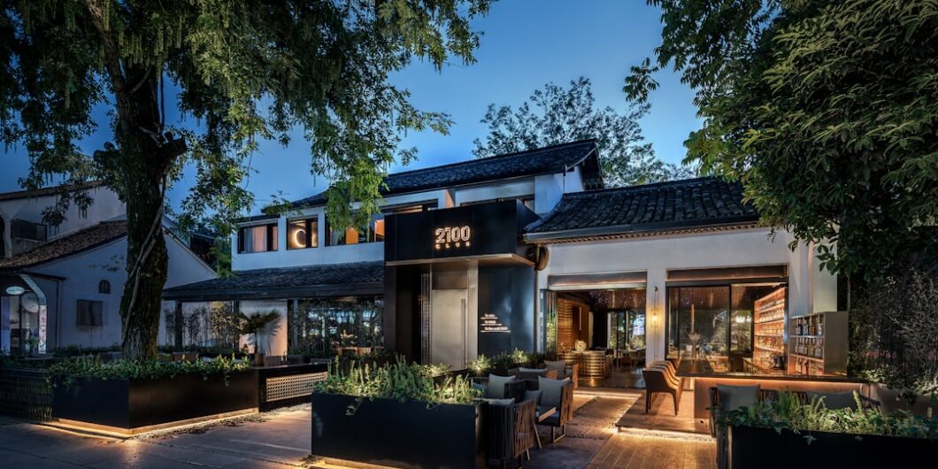 lighted house beside trees