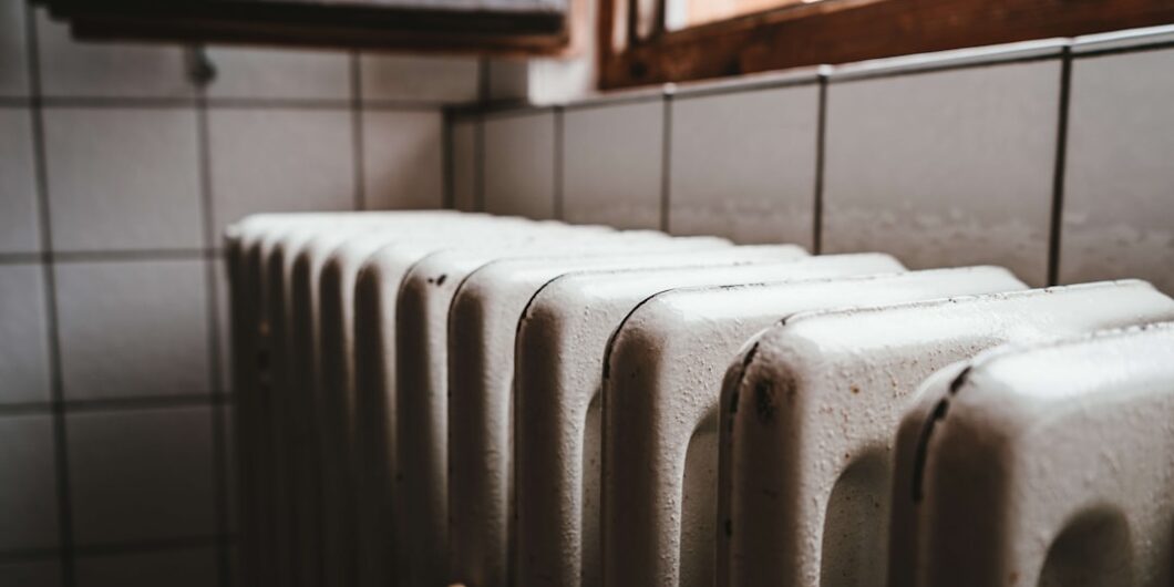 white radiator heater beside brown wooden window