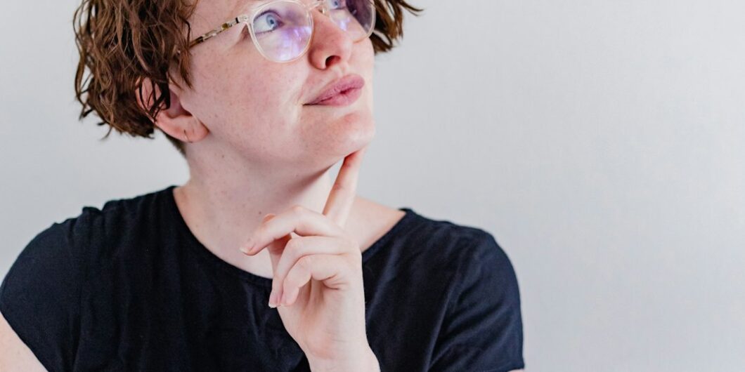 a woman wearing glasses and a black shirt