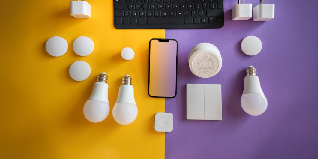 a computer keyboard, light bulbs, and other electronics on a purple and yellow background