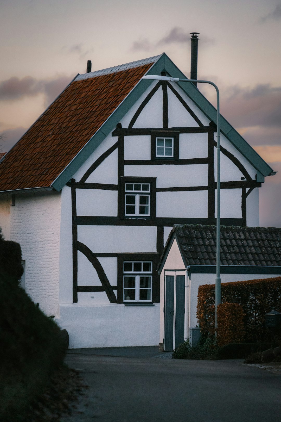 a white and black house with a red roof