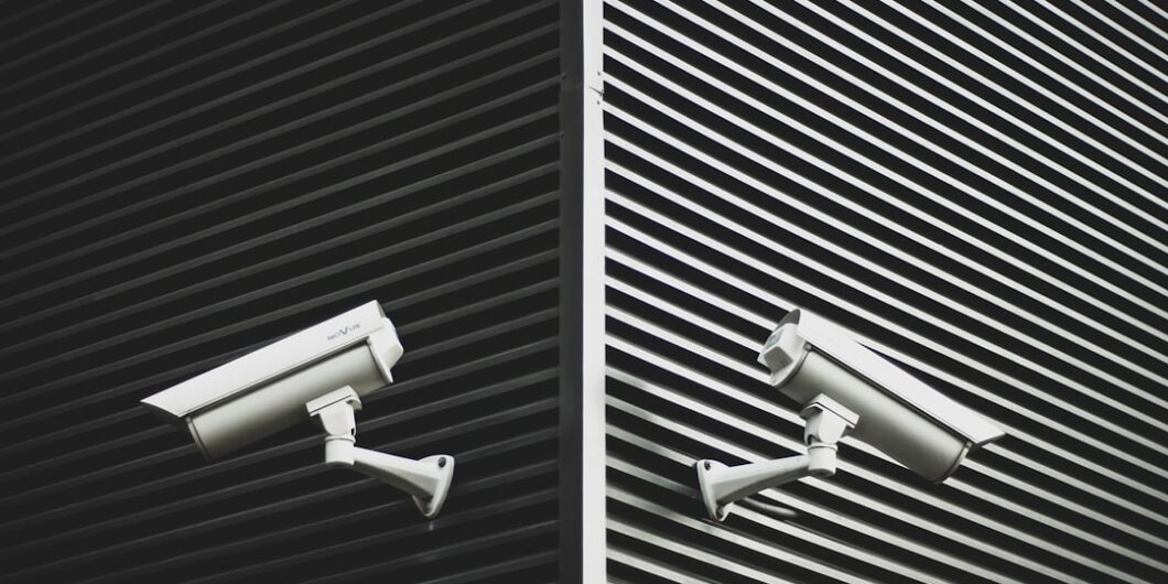two grey CCTV cameras